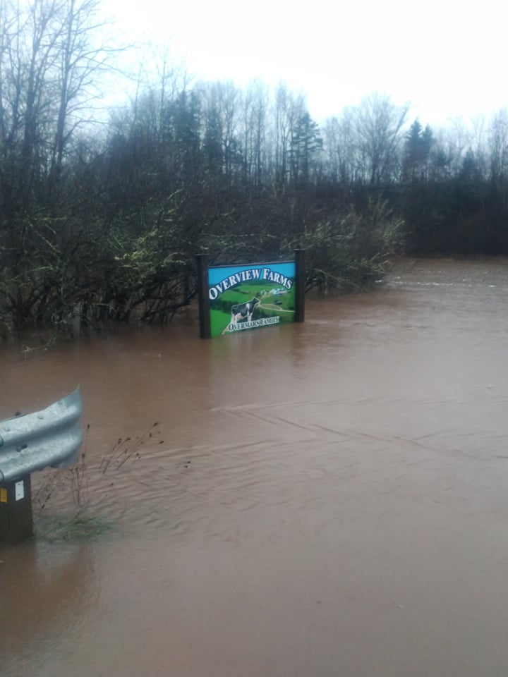 Overview Farms Welcome Sign, submerged in a metre of water.